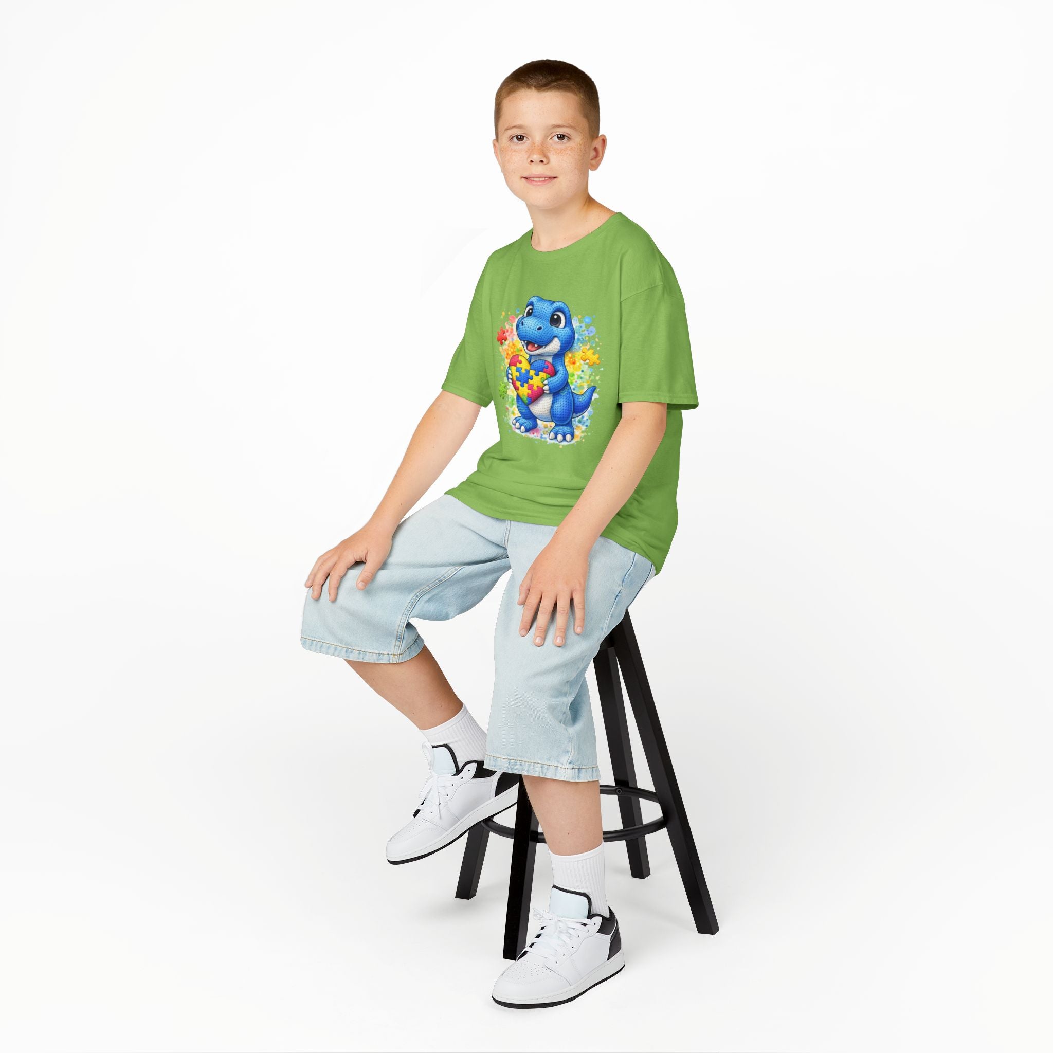 Kids T‑Shirt — Cute Blue Dinosaur Holding Puzzle Heart (Autism Awareness)