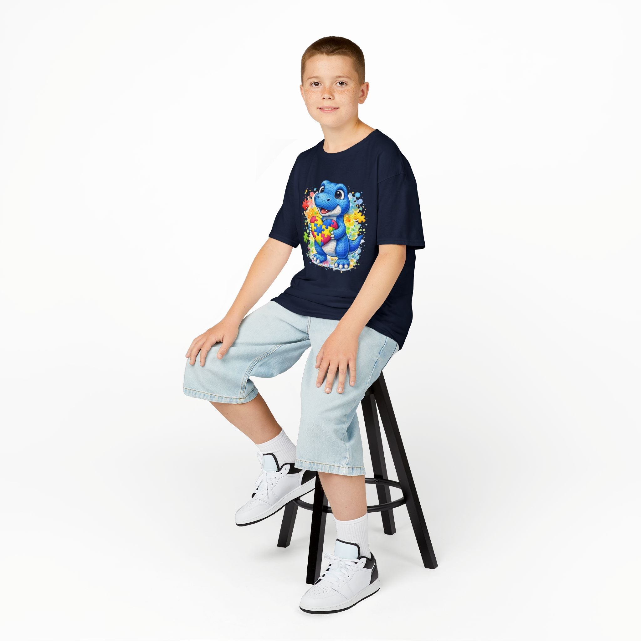 Kids T‑Shirt — Cute Blue Dinosaur Holding Puzzle Heart (Autism Awareness)