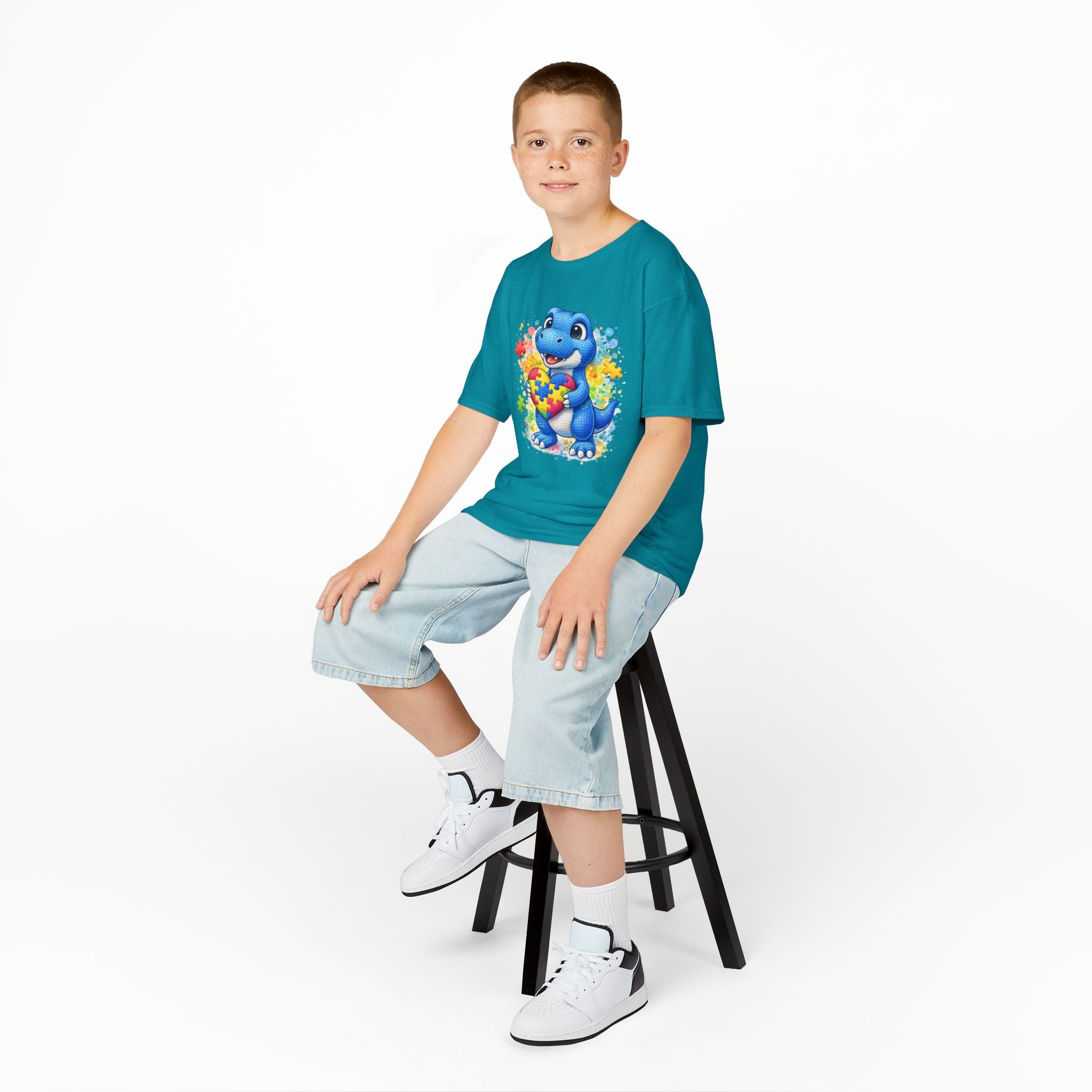Kids T‑Shirt — Cute Blue Dinosaur Holding Puzzle Heart (Autism Awareness)