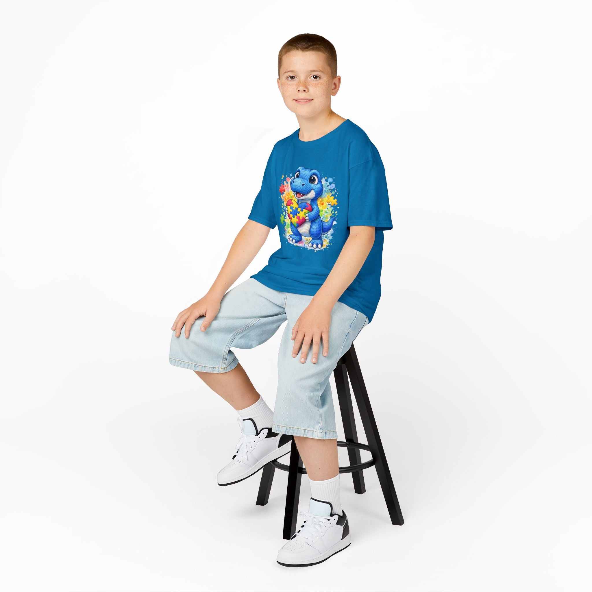 Kids T‑Shirt — Cute Blue Dinosaur Holding Puzzle Heart (Autism Awareness)