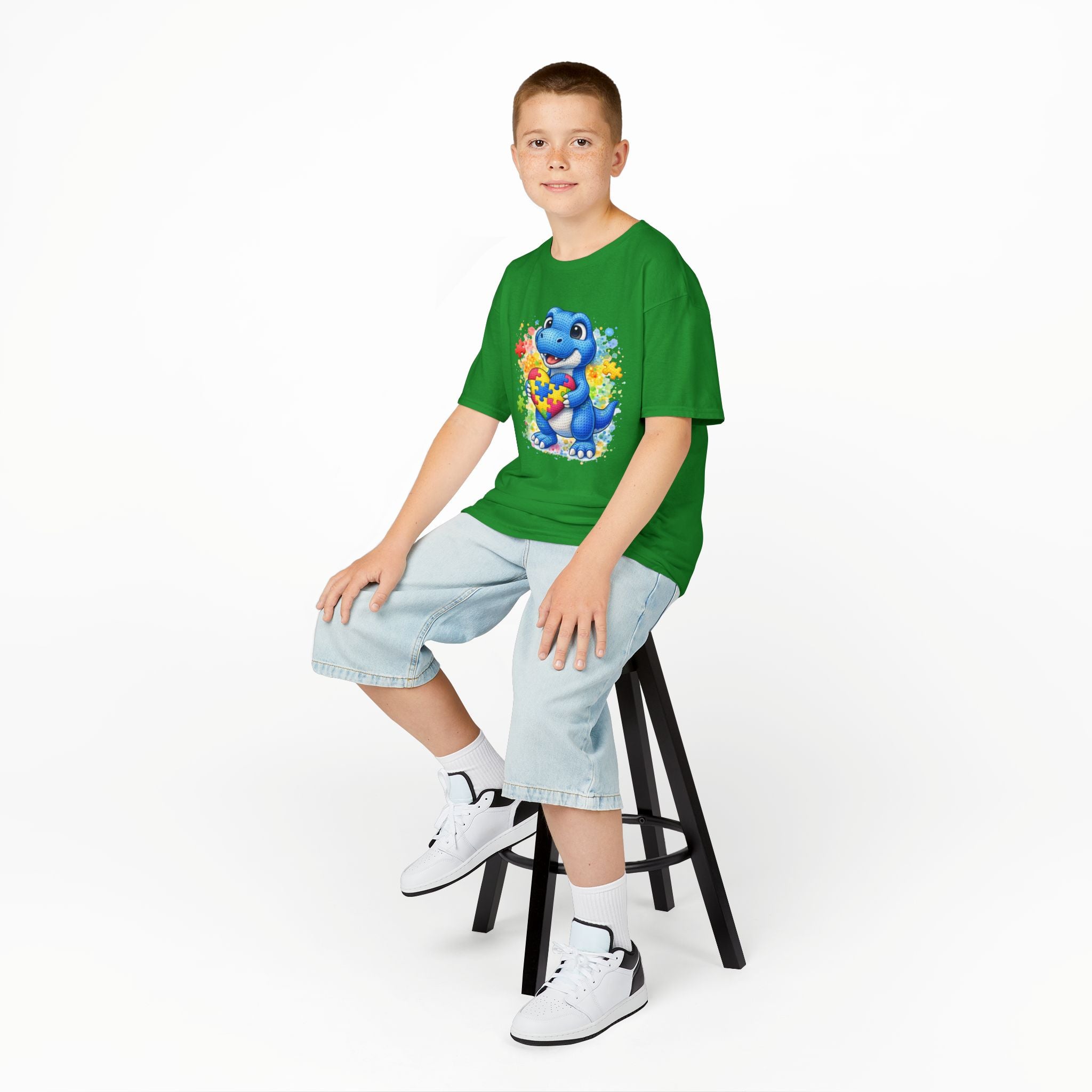 Kids T‑Shirt — Cute Blue Dinosaur Holding Puzzle Heart (Autism Awareness)