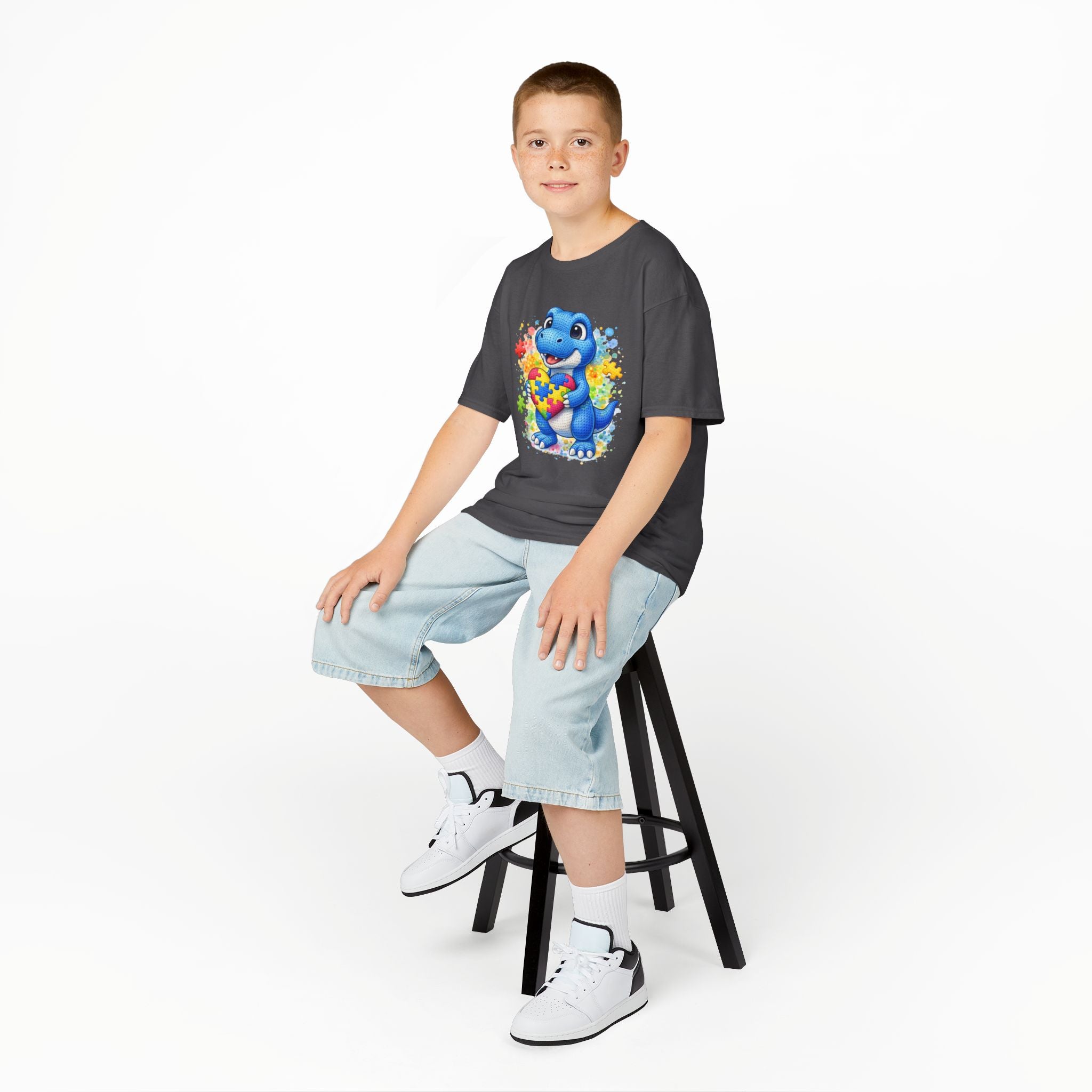 Kids T‑Shirt — Cute Blue Dinosaur Holding Puzzle Heart (Autism Awareness)