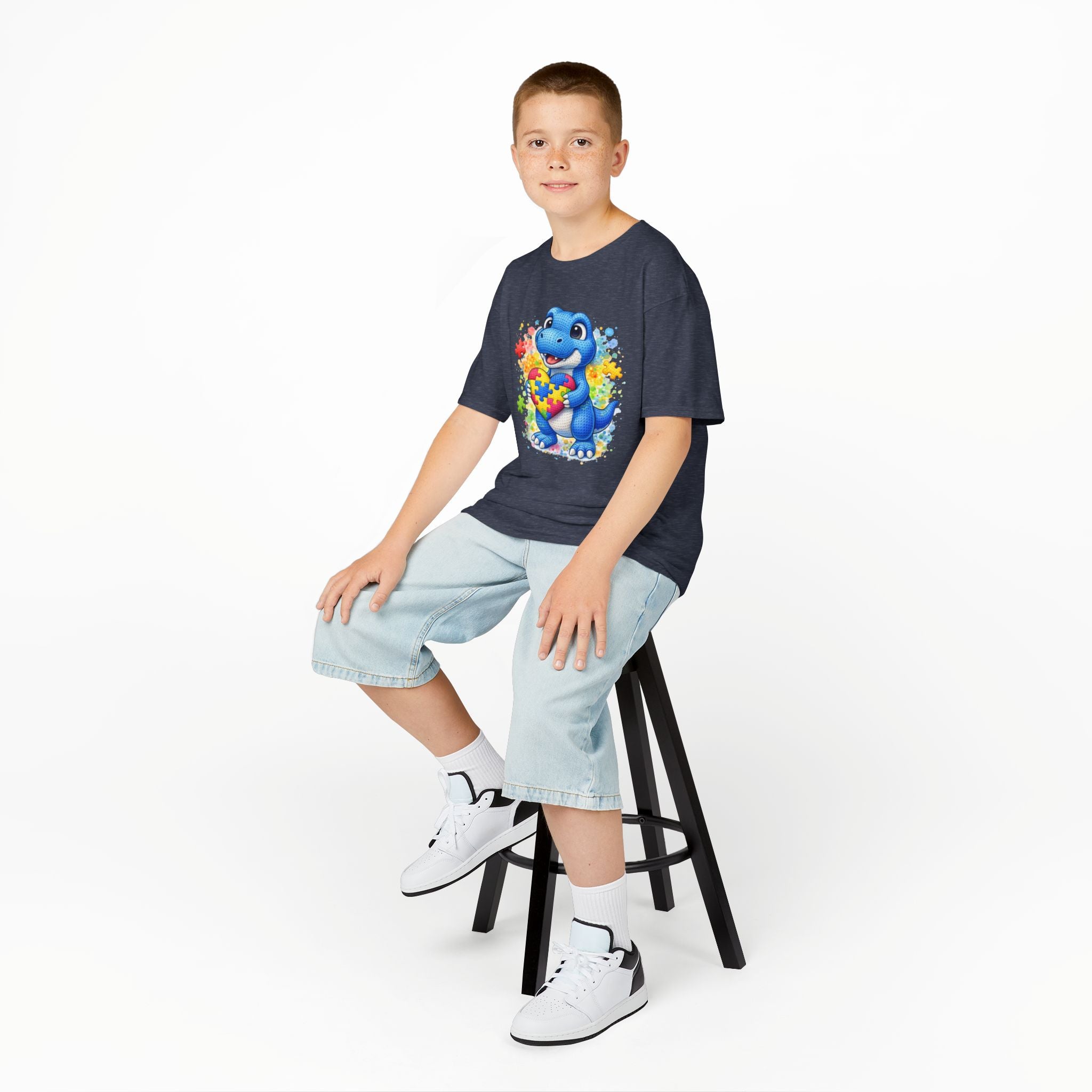 Kids T‑Shirt — Cute Blue Dinosaur Holding Puzzle Heart (Autism Awareness)
