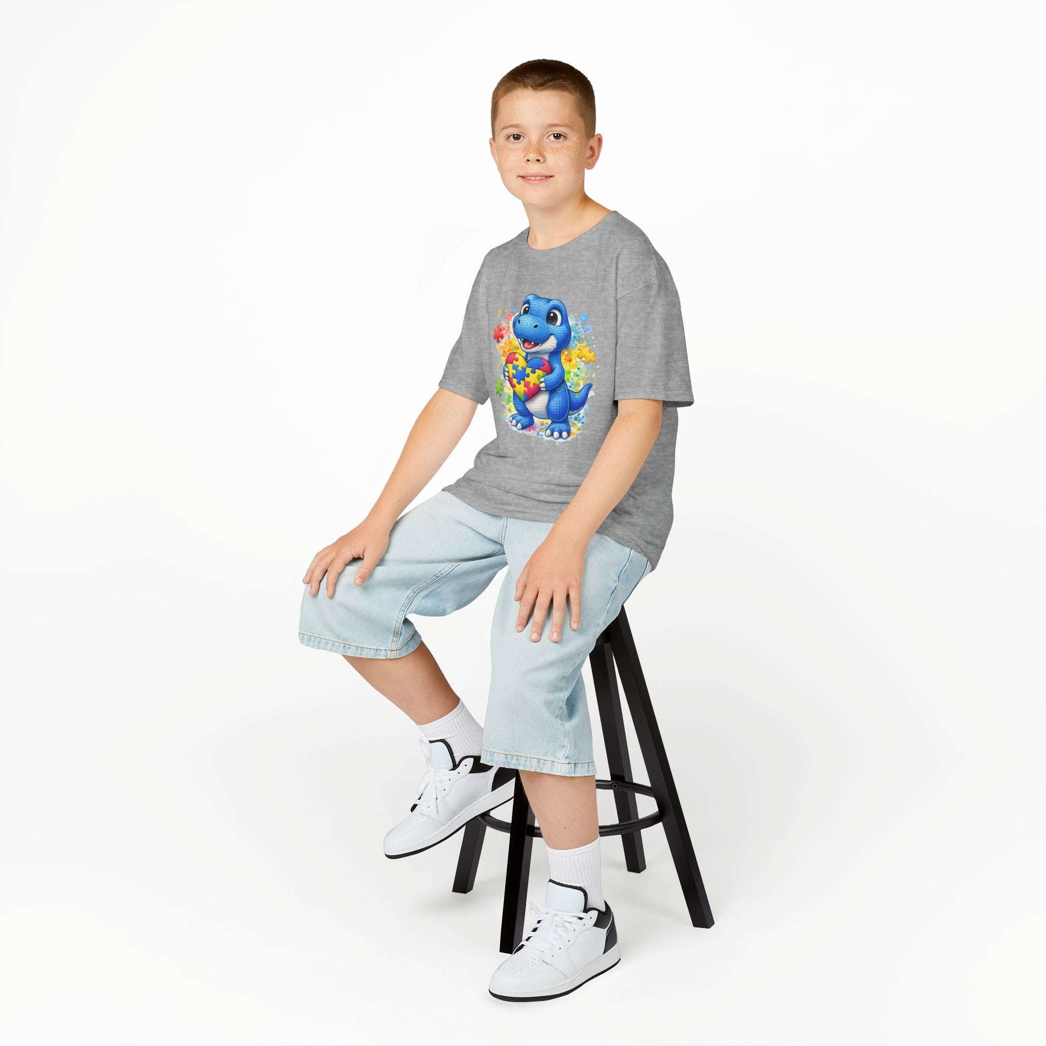 Kids T‑Shirt — Cute Blue Dinosaur Holding Puzzle Heart (Autism Awareness)