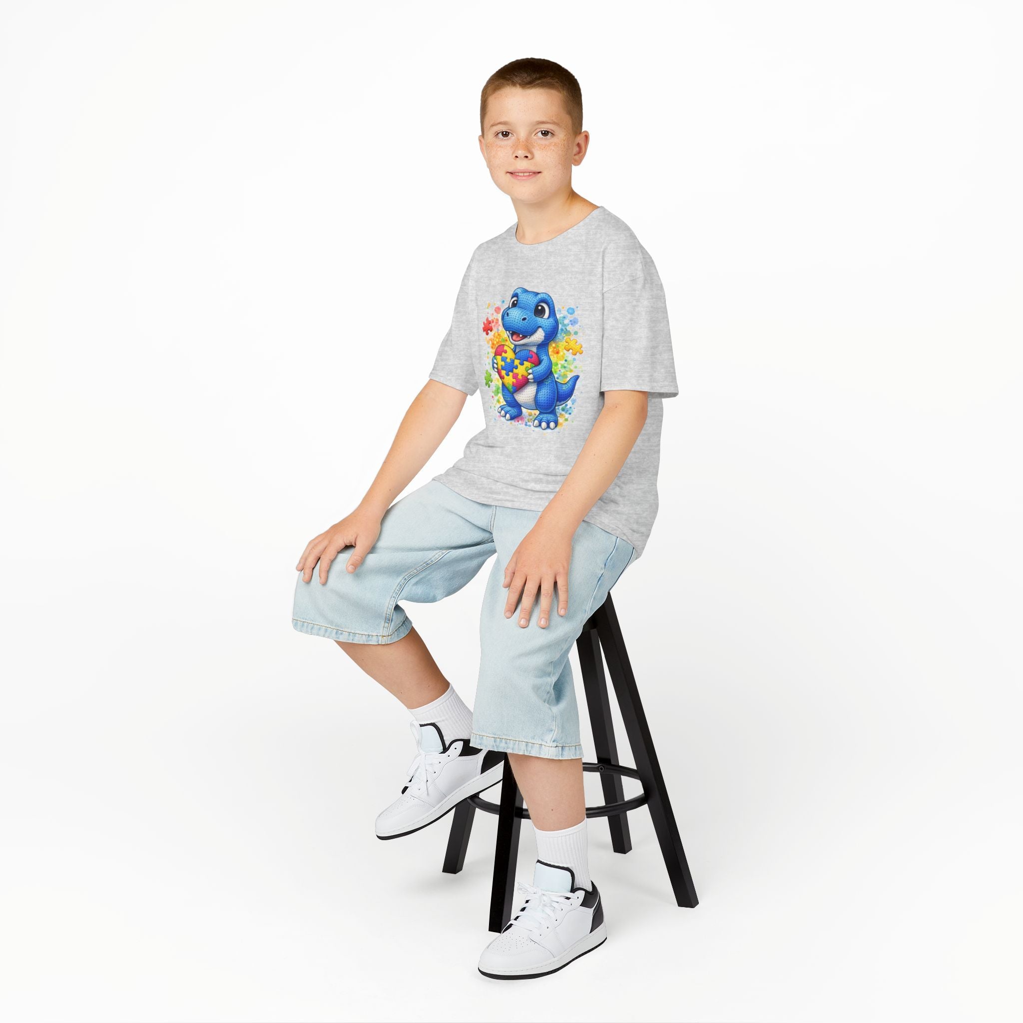 Kids T‑Shirt — Cute Blue Dinosaur Holding Puzzle Heart (Autism Awareness)
